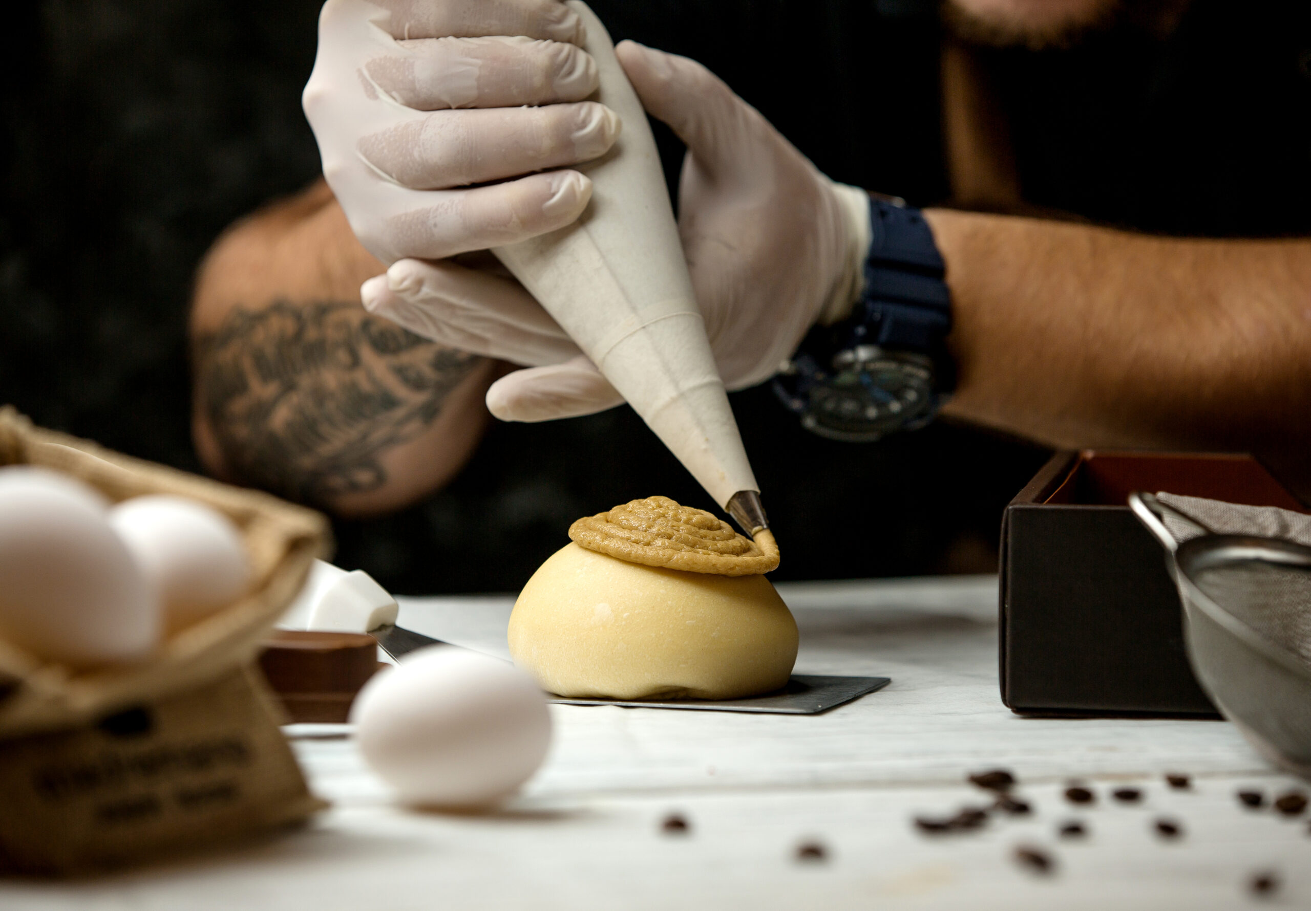 Piping cream charger onto dessert